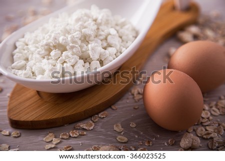 Cottage cheese, eggs on the background of scattered muesli. Picture taken in the studio