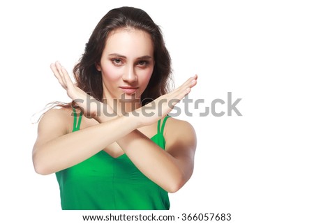 Portrait of a beautiful girl showing stop sign with hands crossed isolated on a white background