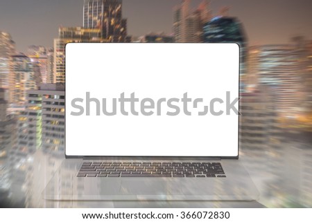 computer with blank white screen with blur city light background