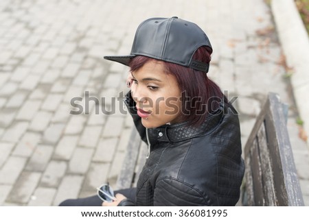 Young woman with baseball cap, urban style.