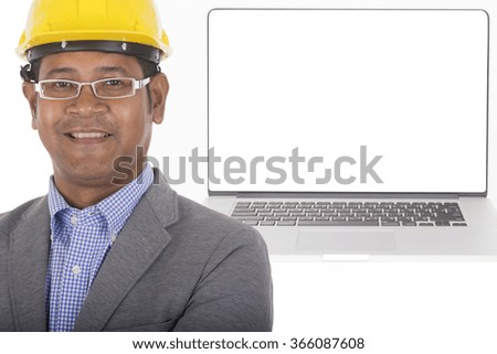male engineer standing with computer and blank white screen in background