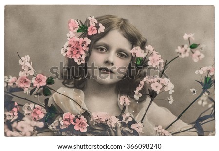 Portrait of little girl with flowers. Vintage picture with original film grain and blur