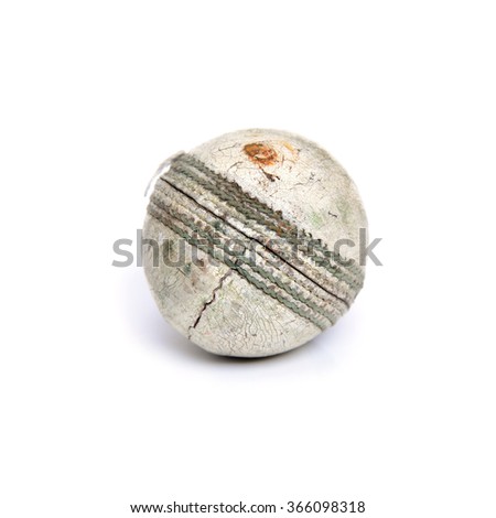 Old white leather cricket ball isolated against a white background
