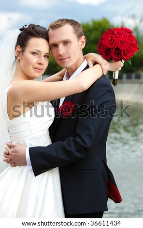 Young wedding couple in a city.