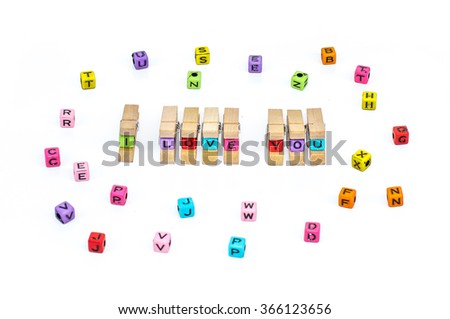 Wooden clamps have Message I love you spelled in plastic blocks with over white background and other alphabet