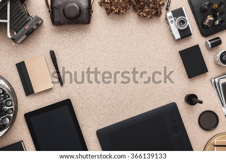 Desktop with Camera; Photographer workplace. Scrapbook and cameras. Tradional Photography. Black and White Photography. Tablet.