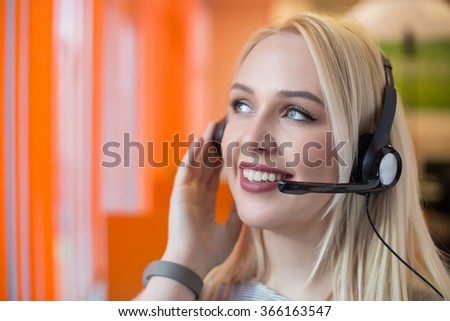 Portrait of support phone operator in headset at workplace. To provide maximum quality, I have made this image by combination of two photos. You can use left part for slogan, big text or banner.