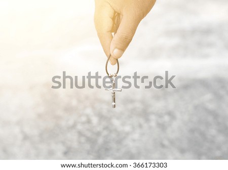 Necklace with a cross in hand