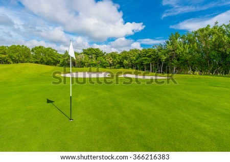 White flag and sand bunkers at the beautiful golf course.