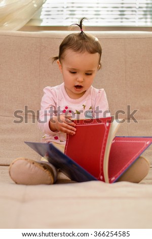 Baby reading a children's book