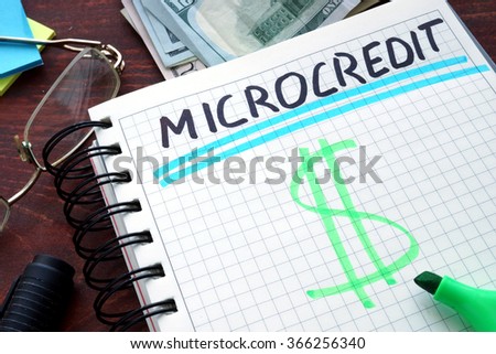 Microcredit written on a notebook. Business concept. Royalty-Free Stock Photo #366256340