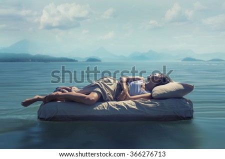 Sleeping woman lies on airbed in water. Royalty-Free Stock Photo #366276713