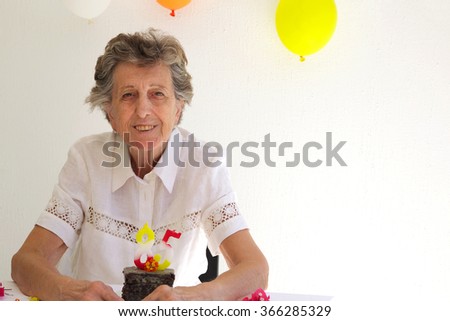 An old woman is celebrationg her 85th birthday.Free space for a text.