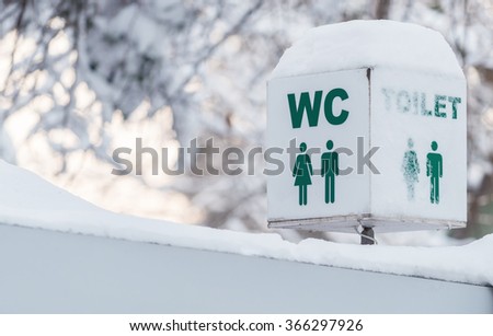 Signs toilet installed on an public ecologic wc, covered in snow in winter season