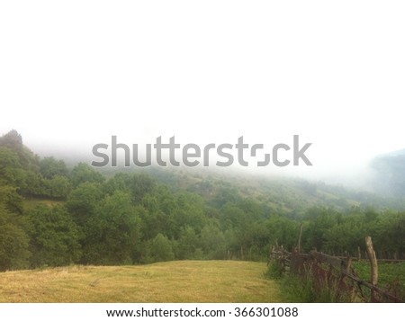 Foggy rural landscape in Carpathian Mountains in Romania