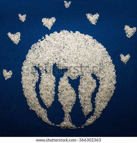 Valentine's Day card made of rice. Two cats in the background of the moon.
