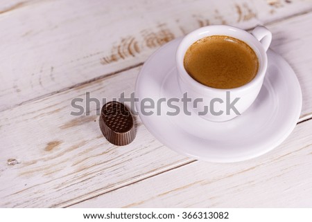 Cup of coffee on a rustic table.