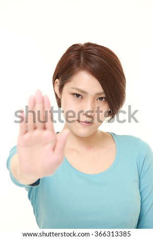 young Japanese woman making stop gesture