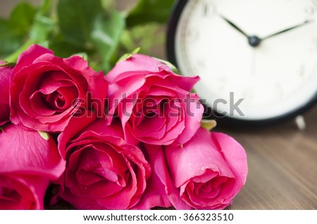Close up Bunch of pink roses with blur clock