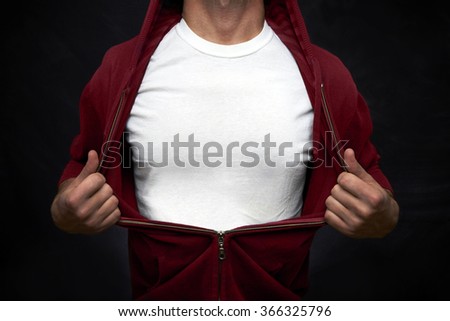 Hero pulling open red blouse showing white t-shirt on blackboard background Royalty-Free Stock Photo #366325796