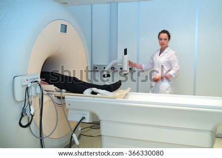 CT (computer tomography) scanner with radiologic technician and male patient in hospital 