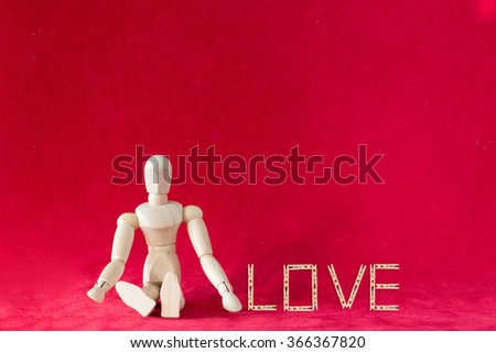 Valentine concept with wood figure and Caption word love made by clothes pin