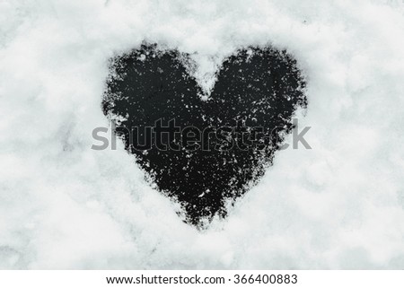 Black background shape of heart in the snow. Perfect window frame for any picture, just replace black color with your image in photo editor, by layered over it in screen mode.