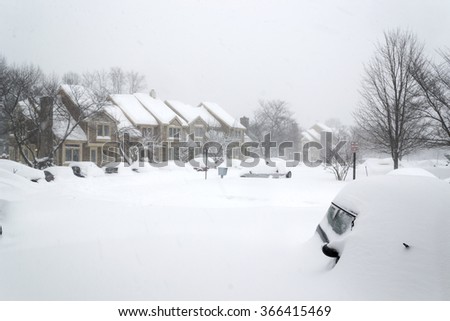 Cars covered in snow during snow Blizzard in Washington DC area. neighborhood houses