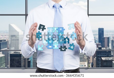 A man holding a puzzle of different life components, several parts missing. Front view, no face. City view at the background. Concept of getting a full picture.