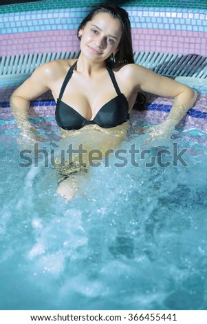Portrait of a young woman relaxing in a swimming pool