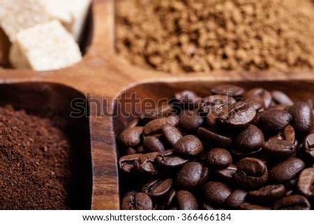 Different kinds of coffee on wooden plate. Selective focus.