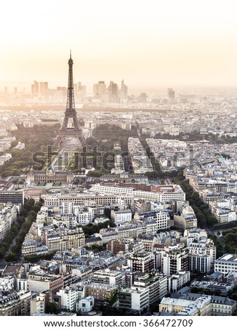 Eiffel Tower and city of Paris with colorful soft diffused light in the background