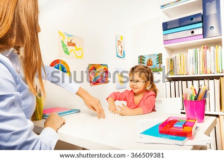 Little girl showing small man with her fingers