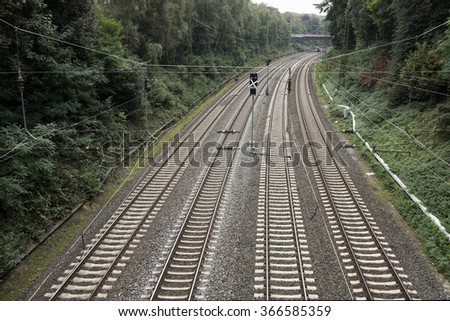Railroad with four tracks through a forest in Germany                               