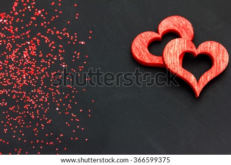 two red hearts dark background