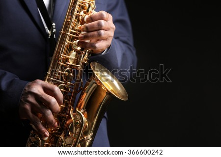 African American jazz musician playing the saxophone, closeup Royalty-Free Stock Photo #366600242