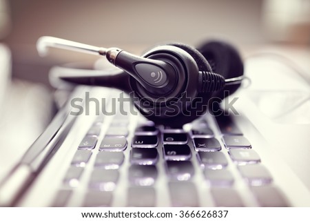 VOIP headset on laptop computer keyboard concept for communication, it support, call center and customer service help desk Royalty-Free Stock Photo #366626837