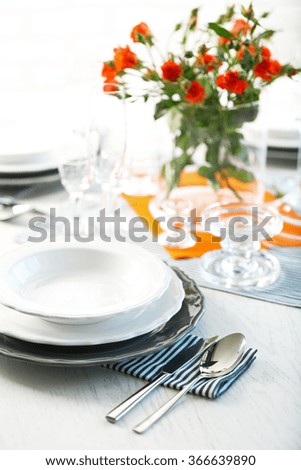 Served table with flowers in restaurant, closeup