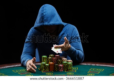 Poker player showing a pair of aces Royalty-Free Stock Photo #366651887