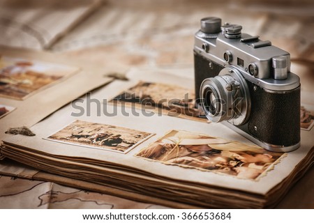 Photo album with photos of travel and vintage old camera on a background of old maps Royalty-Free Stock Photo #366653684