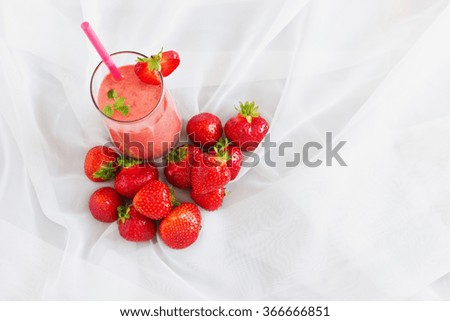 glass of strawberry smoothie and ripe strawberries on the table. health and diet concept. selective focus. top view. copy space background