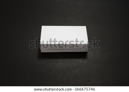 blank business cards stack up on Black background