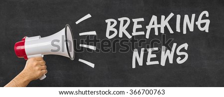 A man holding a megaphone - Breaking news Royalty-Free Stock Photo #366700763
