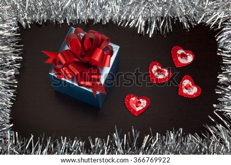 Valentine gift box with small hearts on wooden table