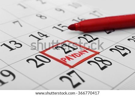 Payday concept. Calendar with red felt pen background. Date in frame, close up