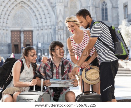 positive russian tourists with map exploring the city destination