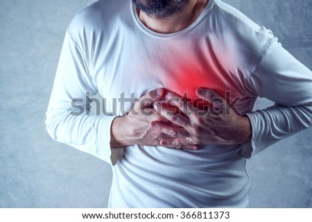 Severe heartache, man suffering from chest pain, having heart attack or painful cramps, pressing on chest with painful expression. Royalty-Free Stock Photo #366811373
