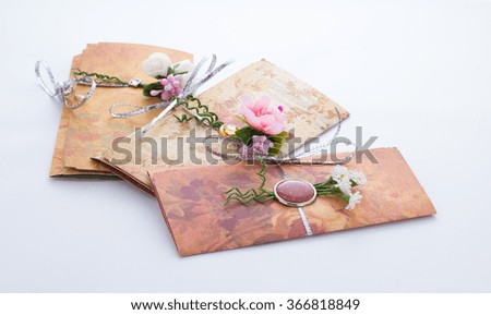 Hand made invitation with interesting decorations over grey background
