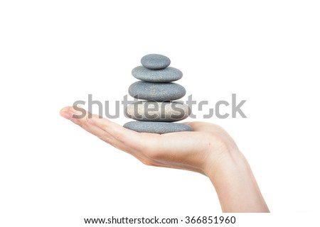 Hand with balancing stones - work life balance concept 