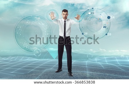 Future technology concept. Frustrated business man trying to control new interface